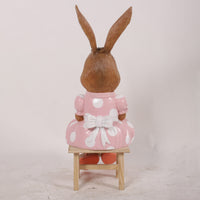 Young Rabbit Girl Sitting Over Sized Statue